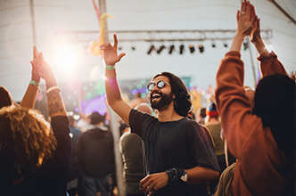 Man with sunglasses attending an outdoor concert